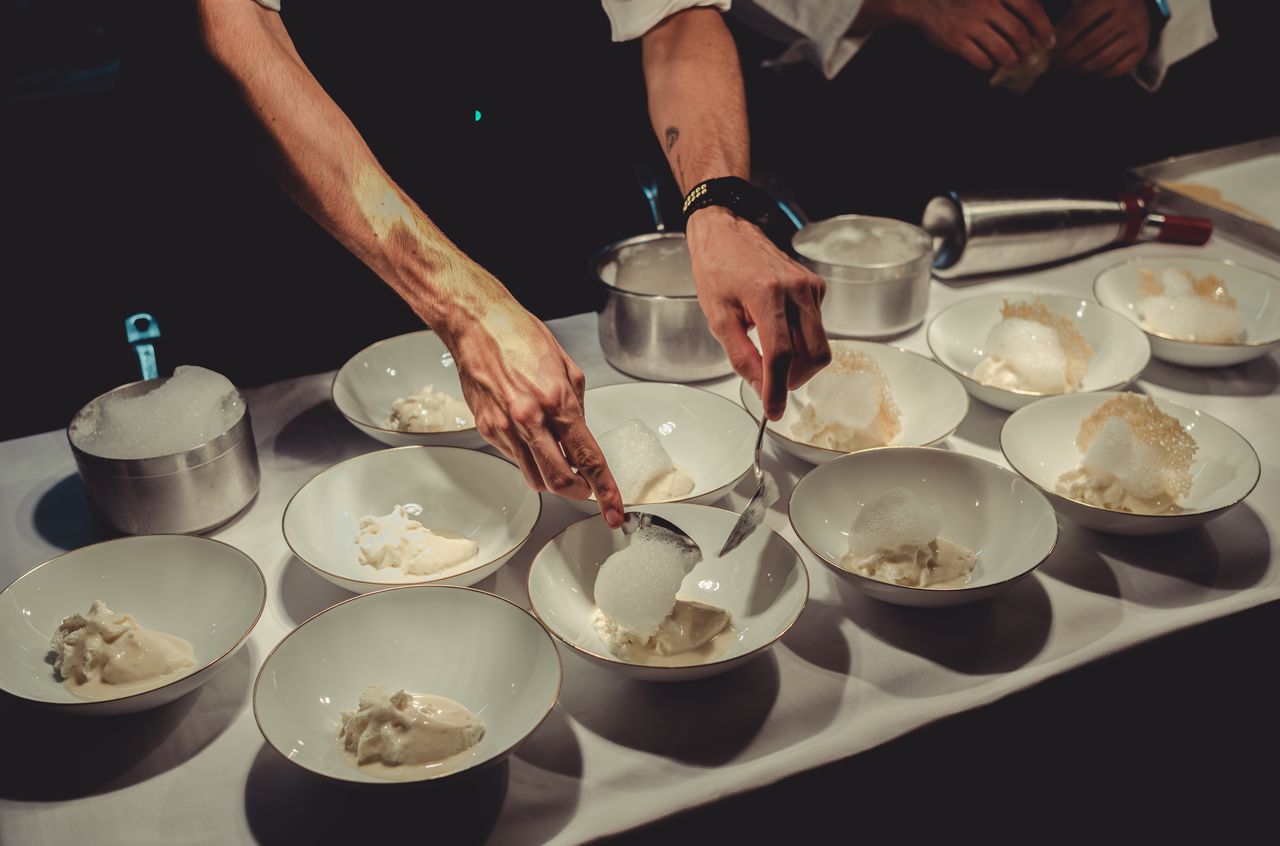 Chefs carefully plate &quot;Five Ages of Parmigiano Reggiano&quot; at Francescana at Maria Luigia, a three-Michelin-star restaurant.